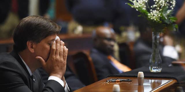 State Senator Vincent Sheheen (D-Kershaw) sitting next to the draped desk of state Sen. Clementa Pinckney in 2015.