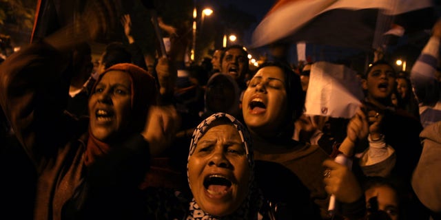 Dec, 18, 2012: Egyptian protesters opposing president Mohammed Morsi chant slogans during a protest against President Mohammed Morsi, in front of the presidential palace in Cairo, Egypt.