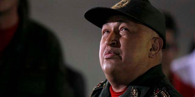 Venezuela's President Hugo Chavez looks up upon his arrivals to Miraflores presidential palace after his third round of chemotherapy for cancer.in Caracas, Venezuela, Friday, Sept. 2, 2011. Venezuelan President Hugo Chavez said he felt great and playfully boxed for television cameras as he emerged from his third round of chemotherapy for cancer.(AP Photo/Fernando Llano)