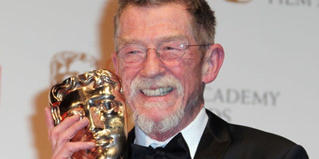 FILE 2012: Actor Sir John Hurt posing with his award for "Outstanding Contribution to Cinema" backstage at The Royal Opera House in London.