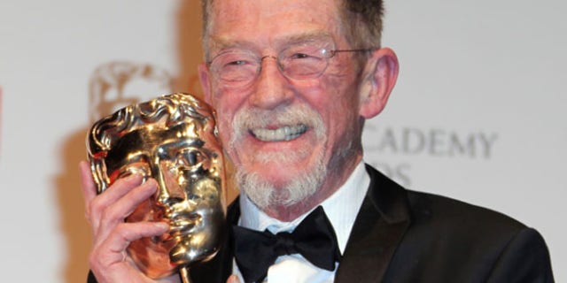FILE 2012: Actor Sir John Hurt posing with his award for "Outstanding Contribution to Cinema" backstage at The Royal Opera House in London.