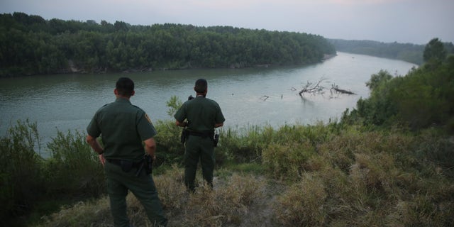 MISSION, TX - JULY 24: U.S. Border Patrol agents look for immigrants crossing the Rio Grande from Mexico (L), to the United States at dusk on July 24, 2014 near Mission, Texas. Tens of thousands of undocumented immigrants, many of them families or unaccompanied minors, have crossed illegally into the United States this year and presented themselves to federal agents, causing a humanitarian crisis on the U.S.-Mexico border. Texas' Rio Grande Valley has become the epicenter of the latest immigrant crisis, as more immigrants, especially Central Americans, cross illegally from Mexico into that sector than any other stretch of the America's 1,933 mile border with Mexico. (Photo by John Moore/Getty Images)