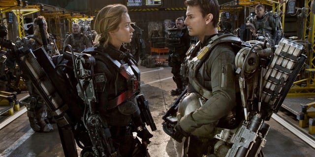 This image released by Warner Bros. Pictures shows Emily Blunt, left, and Tom Cruise in a scene from "Edge of Tomorrow."