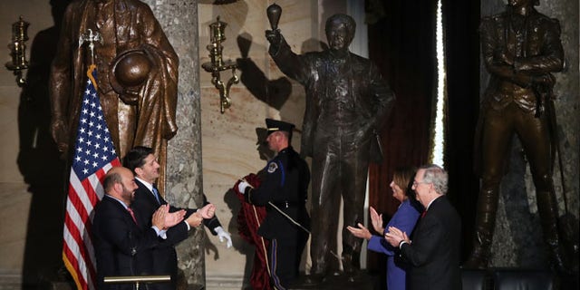 From left, Ohio House of Representatives Speaker Cliff Rosenberger, House Speaker Paul Ryan of Wis., House Minority Leader Nancy Pelosi of Calif., and Senate Majority Leader Mitch McConnell of Ky., applaud during the unveiling of the statue of Thomas Edison in Statuary Hall on Capitol Hill in Washington, Wednesday, Sept. 21, 2016. (AP Photo/Manuel Balce Ceneta)