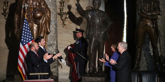 From left, Ohio House of Representatives Speaker Cliff Rosenberger, House Speaker Paul Ryan of Wis., House Minority Leader Nancy Pelosi of Calif., and Senate Majority Leader Mitch McConnell of Ky., applaud during the unveiling of the statue of Thomas Edison in Statuary Hall on Capitol Hill in Washington, Wednesday, Sept. 21, 2016. (AP Photo/Manuel Balce Ceneta)