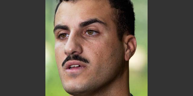 FILE - In this July 19, 2004 file photo, Marine Cpl. Wassef Ali Hassoun makes a statement to the media outside Quantico Marine Base in Quantico, Va. Hassoun, who vanished from his unit in Iraq and later wound up in Lebanon for eight years, will face trial on desertion and other charges, the military said Friday, Sept. 26, 2014. (AP Photo/Steve Helber, File)