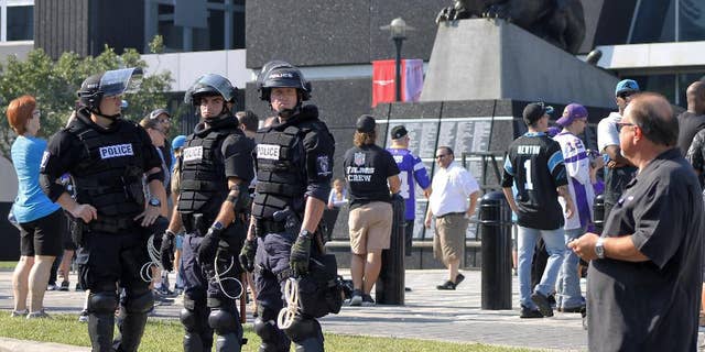 Police officers stand outside Bank of America Stadium for an NFL football game between the Minnesota Vikings and the Carolina Panthers, Sunday, Sept. 25, 2016. Extra security was posted outside the stadium in response to protests over the shooting death of a black man by a police officer on Sept. 20. (AP Photo/Skip Foreman)