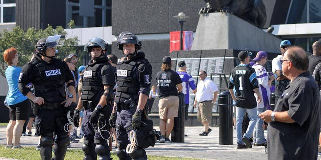 Police officers stand outside Bank of America Stadium for an NFL football game between the Minnesota Vikings and the Carolina Panthers, Sunday, Sept. 25, 2016. Extra security was posted outside the stadium in response to protests over the shooting death of a black man by a police officer on Sept. 20. (AP Photo/Skip Foreman)