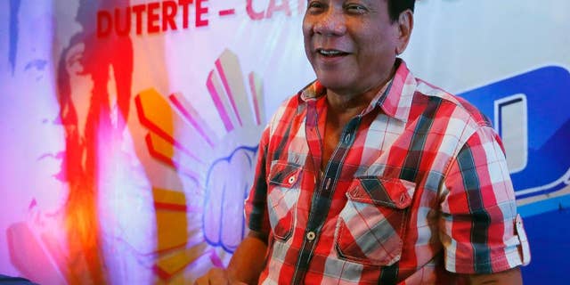 Front-running presidential candidate Mayor Rodrigo Duterte smiles during a news conference shortly after voting in a polling precinct at Daniel R. Aguinaldo National High School, Matina district, his hometown in Davao city, southern Philippines Monday, May 9, 2016. Duterte was the last to vote among five presidential hopefuls. (AP Photo/Bullit Marquez)