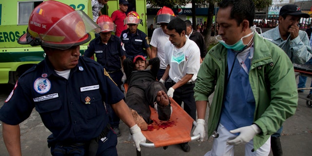 Nov. 7, 2012: Firefighters transport a wounded resident into a public hospital after he was injured in a magnitude 7.4 earthquake that struck in San Marcos, Guatemala.