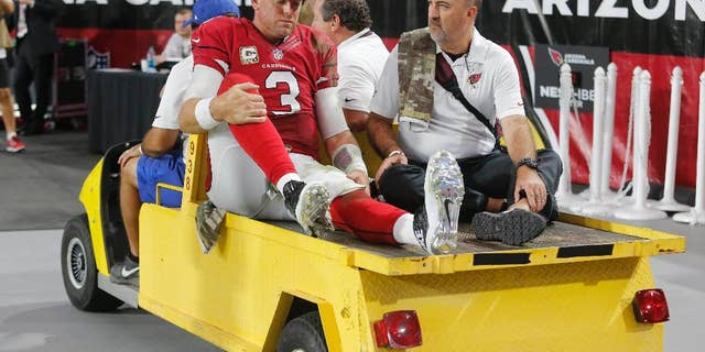 Arizona Cardinals quarterback Carson Palmer (3) leaves the NFL football game against the St. Louis Rams after an injury during the second half, Sunday, Nov. 9, 2014, in Glendale, Ariz. (AP Photo/Rick Scuteri)