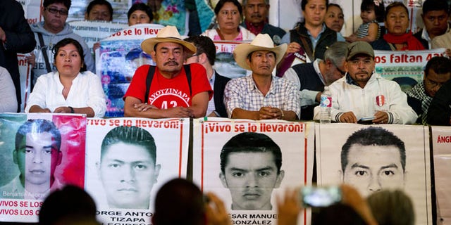 Relatives of 43 missing students, accompanied by their spokesman and human rights activists, take their seats during a press conference. (AP Photo/Rebecca Blackwell)