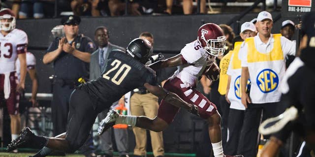Temple's Jalen Fitzpatrick stiff-arm's Vanderbilt's Oren Burks on his way to a touchdown during the second quarter of an NCAA college football game Thursday, Aug. 28, 2014, in Nashville, Tenn. (AP Photo/Brian Powers)