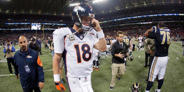 Denver Broncos quarterback Peyton Manning walks off the field following a 22-7 loss to the St. Louis Rams in an NFL football game Sunday, Nov. 16, 2014, in St. Louis. (AP Photo/Charlie Riedel)