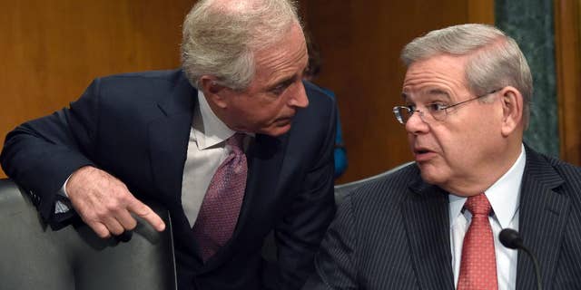 FILE - In this Jan. 27, 2015 file photo, Senate Foreign Relations Committee Chairman Sen. Bob Corker, R-Tenn., left, talks with the committee's tanking member Sen. Robert Menendez, D-N.J. on Capitol Hill in Washington. A bill calling for Congress to have a say about an emerging nuclear agreement with Iran has turned into a tug of war on Capitol Hill with Republicans trying to raise the bar so high that a final deal might be impossible and Democrats aiming to give the White House more room to negotiate with Tehran. Democratic and GOP senators are considering more than 50 amendments to a controversial bill introduced by Corker and Menendez. The bill would restrict Obama’s ability to ease sanctions against Iran without congressional approval.(AP Photo/Susan Walsh, File)