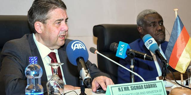 Germany's Foreign Minister Sigmar Gabriel, left, speaks to media accompanied by African Union (AU) chairman Moussa Faki Mahamat, at the AU headquarters in Addis Ababa, Ethiopia Tuesday, May 2, 2017. Germany's foreign minister and the African Union chief say setting up camps in North Africa will not solve Europe's migrant crisis and that stabilizing African countries is a better strategy. (AP Photo/Daniel Getachew)