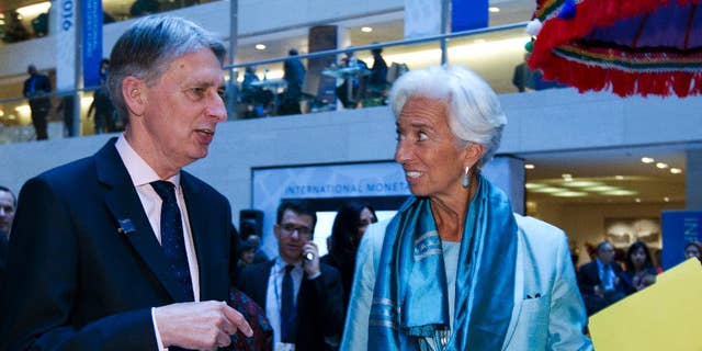International Monetary Fund (IMF) Managing Director Christine Lagarde speaks with Chancellor of the Exchequer Philip Hammond after a news conference at World Bank/IMF Annual Meetings at IMF headquarters in Washington, Saturday, Oct. 8, 2016. ( AP Photo/Jose Luis Magana)