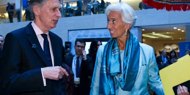 International Monetary Fund (IMF) Managing Director Christine Lagarde speaks with Chancellor of the Exchequer Philip Hammond after a news conference at World Bank/IMF Annual Meetings at IMF headquarters in Washington, Saturday, Oct. 8, 2016. ( AP Photo/Jose Luis Magana)