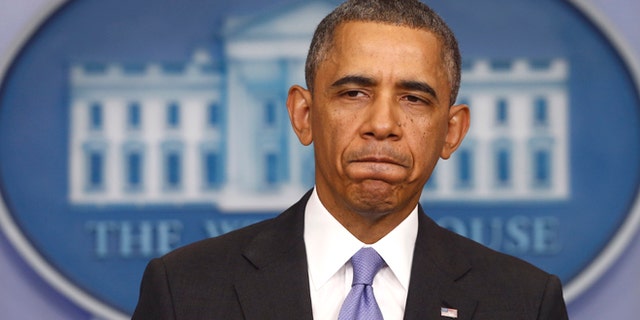 President Barack Obama pauses while speaking about his signature health care law, Thursday, Nov. 14, 2013, in the Brady Press Briefing Room of the White House in Washington. Bowing to pressure, President Barack Obama intends to permit continued sale of individual insurance plans that have been canceled because they failed to meet coverage standards under the health care law, officials said Thursday. (AP Photo/Charles Dharapak)