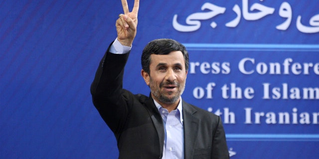 June 7: Iranian President Mahmoud Ahmadinejad flashes a victory sign as he arrives for his press conference in Tehran, Iran.