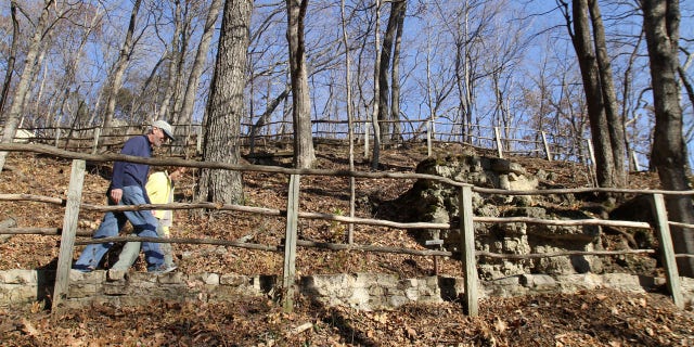 In this Nov. 8, 2010, file photo, pedestrians hike one of the trails at Effigy Mounds National Monument in Harpers Ferry, Iowa.
