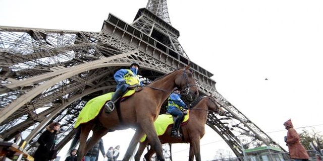 Police keep watch at Paris' Eiffel Tower.
