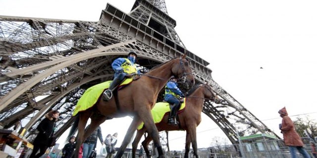 Police keep watch at Paris' Eiffel Tower.