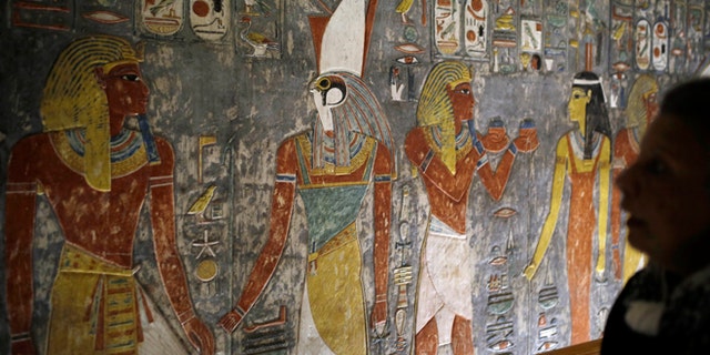 Nov. 5, 2015: A visitor looks at colored carvings on a wall at the Horemheb tomb, the last pharaoh of the 18th Dynasty of Egypt, in the Valley of the Kings in Luxor, Egypt.