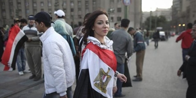 Feb. 13, 2011: A woman wearing an Egyptian flag walks into Tahrir Square, in Cairo, Egypt