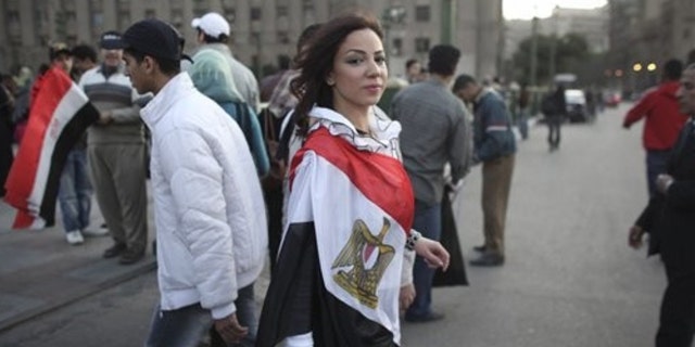 Feb. 13, 2011: A woman wearing an Egyptian flag walks into Tahrir Square, in Cairo, Egypt