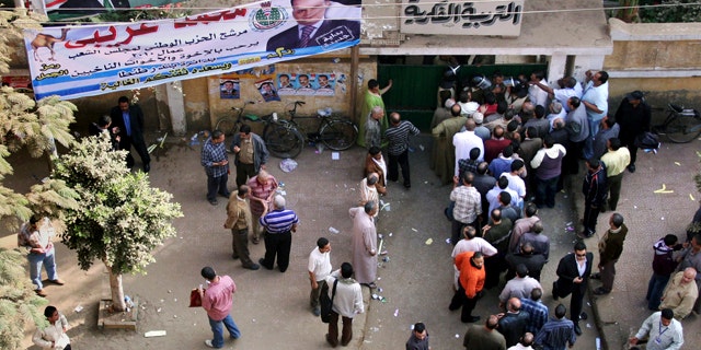 Nov. 28: Egyptians form a line outside a closed polling station in Tanta, north of Cairo, Egypt. Egyptians are choosing a new parliament amid uncertainty over the health of 82-year-old President Hosni Mubarak and widespread frustration over the lack of political reform and economic woes, following a campaign marred by a crackdown on dissent that was seen as an effort by the government to guarantee its powerful grip on authority ahead of a more crucial presidential vote due next year. (AP)