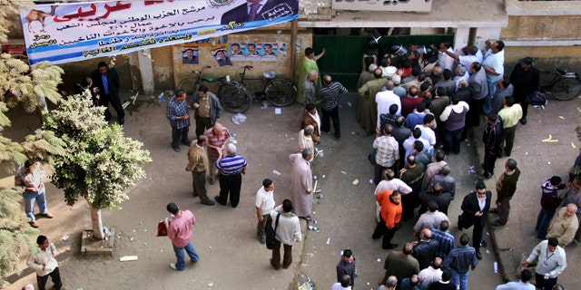 Nov. 28: Egyptians form a line outside a closed polling station in Tanta, north of Cairo, Egypt. Egyptians are choosing a new parliament amid uncertainty over the health of 82-year-old President Hosni Mubarak and widespread frustration over the lack of political reform and economic woes, following a campaign marred by a crackdown on dissent that was seen as an effort by the government to guarantee its powerful grip on authority ahead of a more crucial presidential vote due next year. (AP)