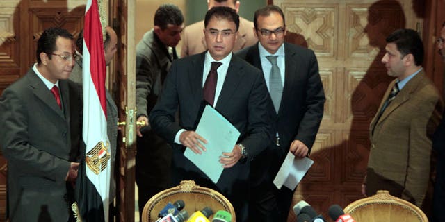 Feb. 8, 2012: Egyptian investigative judges Sameh Abu Zeid, right, and Ashraf el-Ashmawi, who are investigating the case of foreign funding of NGOs, enter a press conference at the Ministry of Justice in Cairo, Egypt.