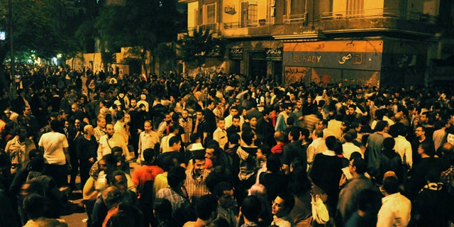 Nov. 19, 2012: Egyptian protesters gather during clashes with security forces, not pictured, in Cairo, Egypt.