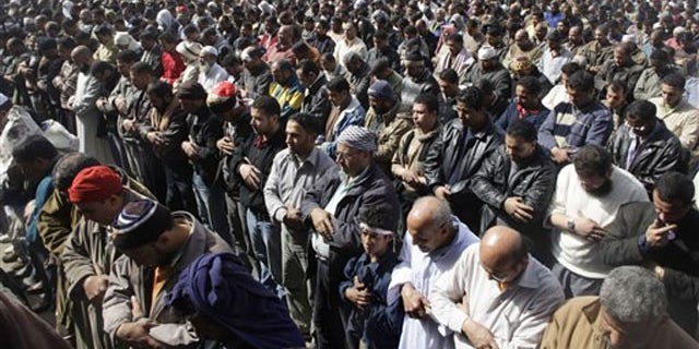 Anti-government protestors pray in Tahrir Square, in Cairo, Egypt, Feb. 4.