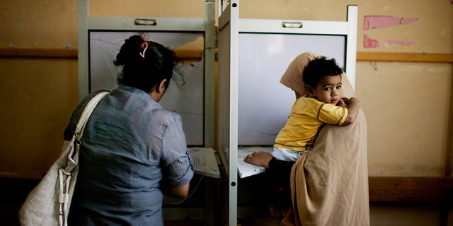 May 24, 2012: Female Egyptian voters cast their votes during the second day of presidential elections in the Mataraya neighborhood of Cairo, Egypt.
