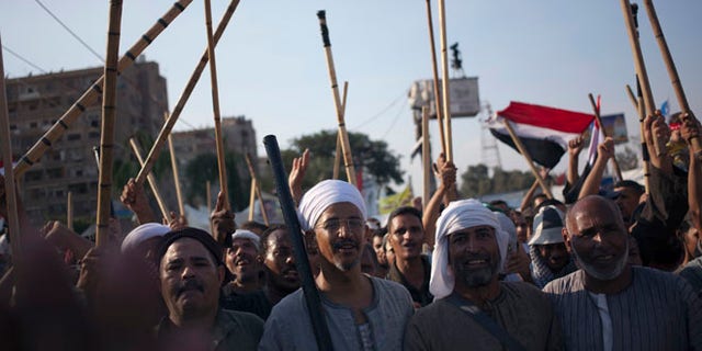 Aug. 10, 2013: Supporters of Egypt's ousted President Mohammed Morsi hold up wooden sticks as they participate in a protest outside Rabaah al-Adawiya mosque, where protesters have installed a camp and held daily rallies at Nasr City, in Cairo, Egypt.