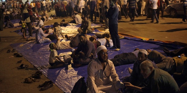 Aug. 2, 2013: Supporters of Egypt's ousted President Mohammed Morsi sit on a street as they protest near Cairo airport in Cairo, Egypt.