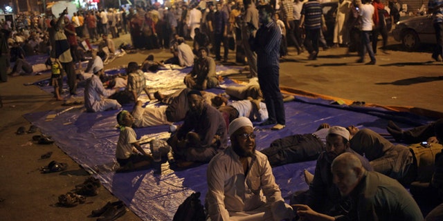 Aug. 2, 2013: Supporters of Egypt's ousted President Mohammed Morsi sit on a street as they protest near Cairo airport in Cairo, Egypt.