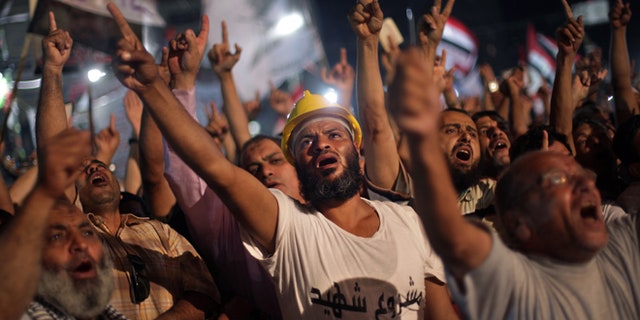 July 31, 2013: Supporters of Egypt's ousted President Mohammed Morsi chant slogans during a protest outside Rabaah al-Adawiya mosque, where they have installed a camp and hold daily rallies at Nasr City, in Cairo, Egypt, Wednesday.