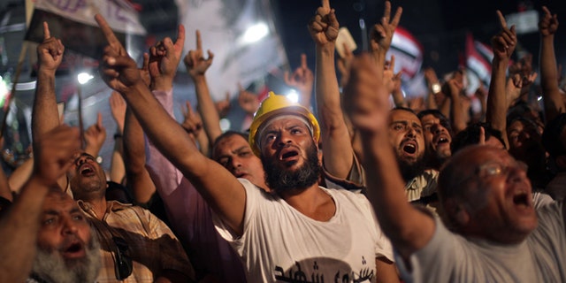 July 31, 2013: Supporters of Egypt's ousted President Mohammed Morsi chant slogans during a protest outside Rabaah al-Adawiya mosque, where they have installed a camp and hold daily rallies at Nasr City, in Cairo, Egypt, Wednesday.