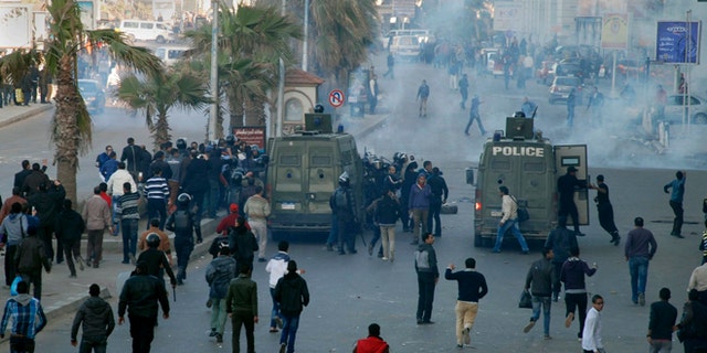 Jan. 19, 2013: Egyptian police and protesters clash outside a courtroom in Alexandria, Egypt.