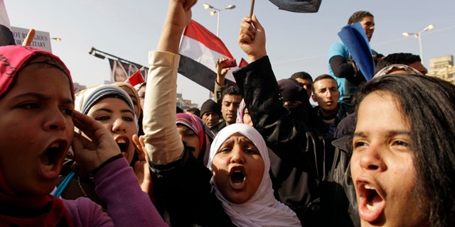 In this Wednesday, Jan. 25, 2012 file photo, Egyptian girls chant slogans in Tahrir Square during a rally to mark the one year anniversary of the uprising that ousted President Hosni Mubarak in Cairo, Egypt.