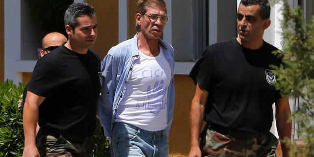 April 22, 2016: EgyptAir plane hijack suspect Seif Eddin Mustafa, 59, 2nd right, with t-shirt is escorted by Cyprus police officers as he arrives in a court in capital Nicosia, Cyprus.