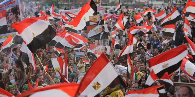 June 3, 2014: Supporters of Abdel-Fattah el-Sissi, the nations former military chief, raise his posters and national flags during a celebration at Tahrir Square in Cairo, Egypt. (AP)