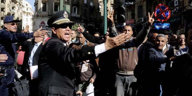 Jan. 29, 2015: Egyptian police try to clear the street where women rally at the spot where Shaimaa el-Sabbagh, a 32-year-old mother, was shot in downtown Cairo on Saturday near Talaat Harb Square, during a protest in Cairo, Egypt. (AP)