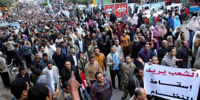 Feb. 6, 2011: Egyptian anti-Mubarak protesters march in al Mansoura city, Egypt.