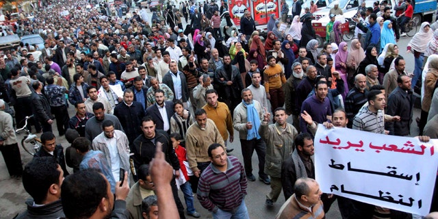 Feb. 6, 2011: Egyptian anti-Mubarak protesters march in al Mansoura city, Egypt.