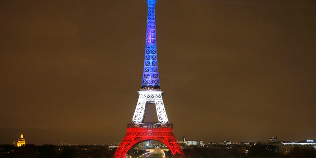 The Eiffel Tower is lit with the blue, white and red colours of the French flag in Paris, France, Nov. 16, 2015, to pay tribute to the victims of a series of deadly attacks on Friday in the French capital. (REUTERS/Charles Platiau)