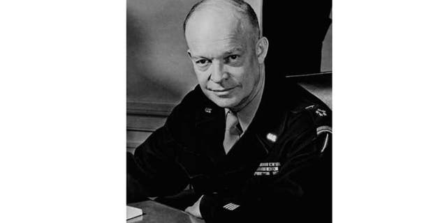 General Dwight D. Eisenhower. Supreme allied Commander, seated at his desk at his headquarters in the European Theater of Operations, February 1, 1945. He wears the Five-Star Cluster and Great Seal of the United States, insignia of the new rank of General of the Army.